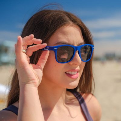 bartaco Blue Sunglasses, Female model at the beach wearing shades