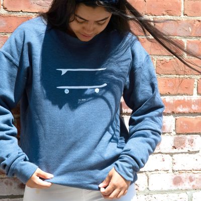 bartaco crew sweatshirt, model outside against a brick wall